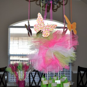 Butterflies and a tulle poof hanging from the chandelier